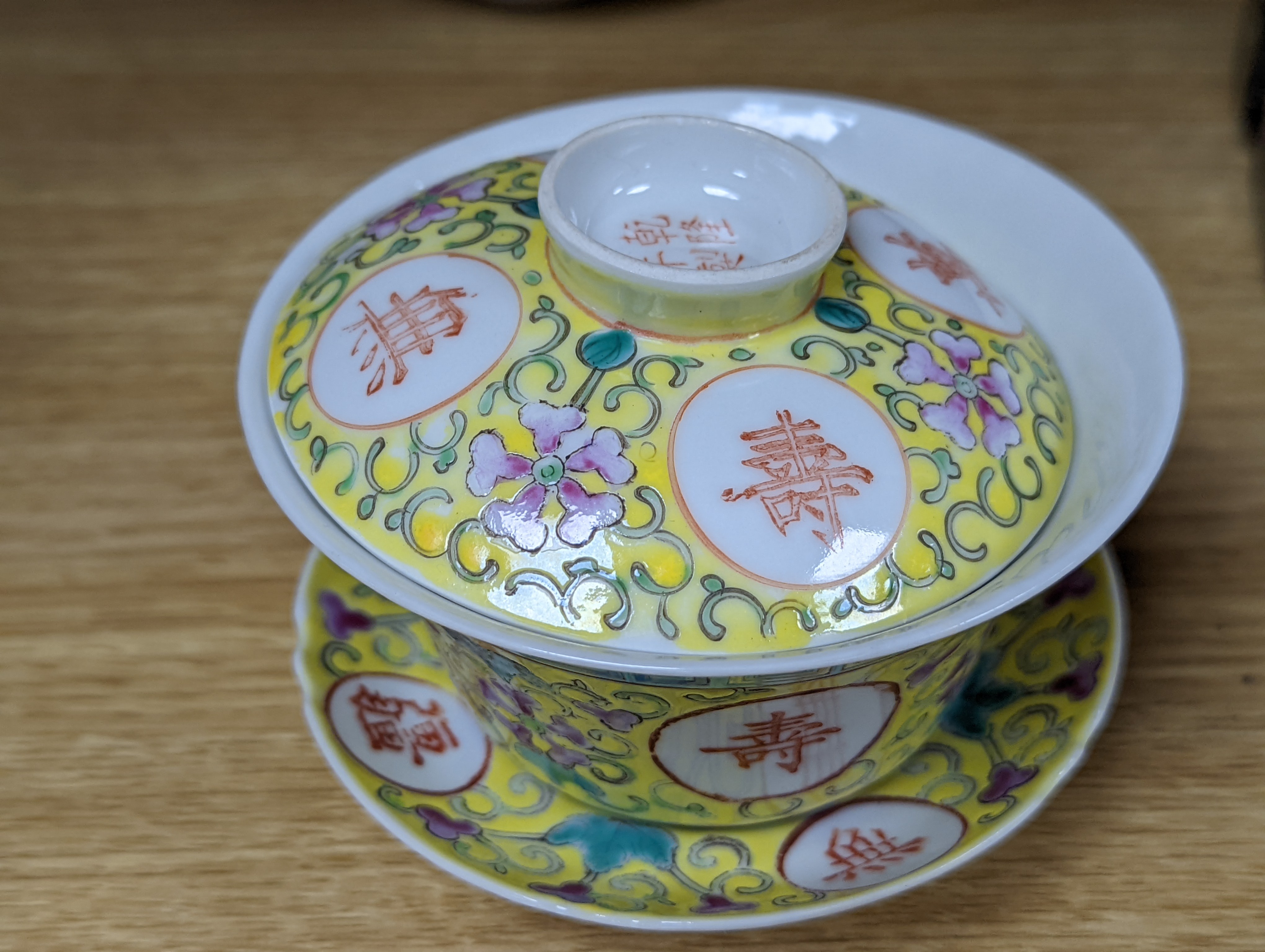 A pair of Chinese enamelled porcelain rice bowls, covers and stands and an odd bowl